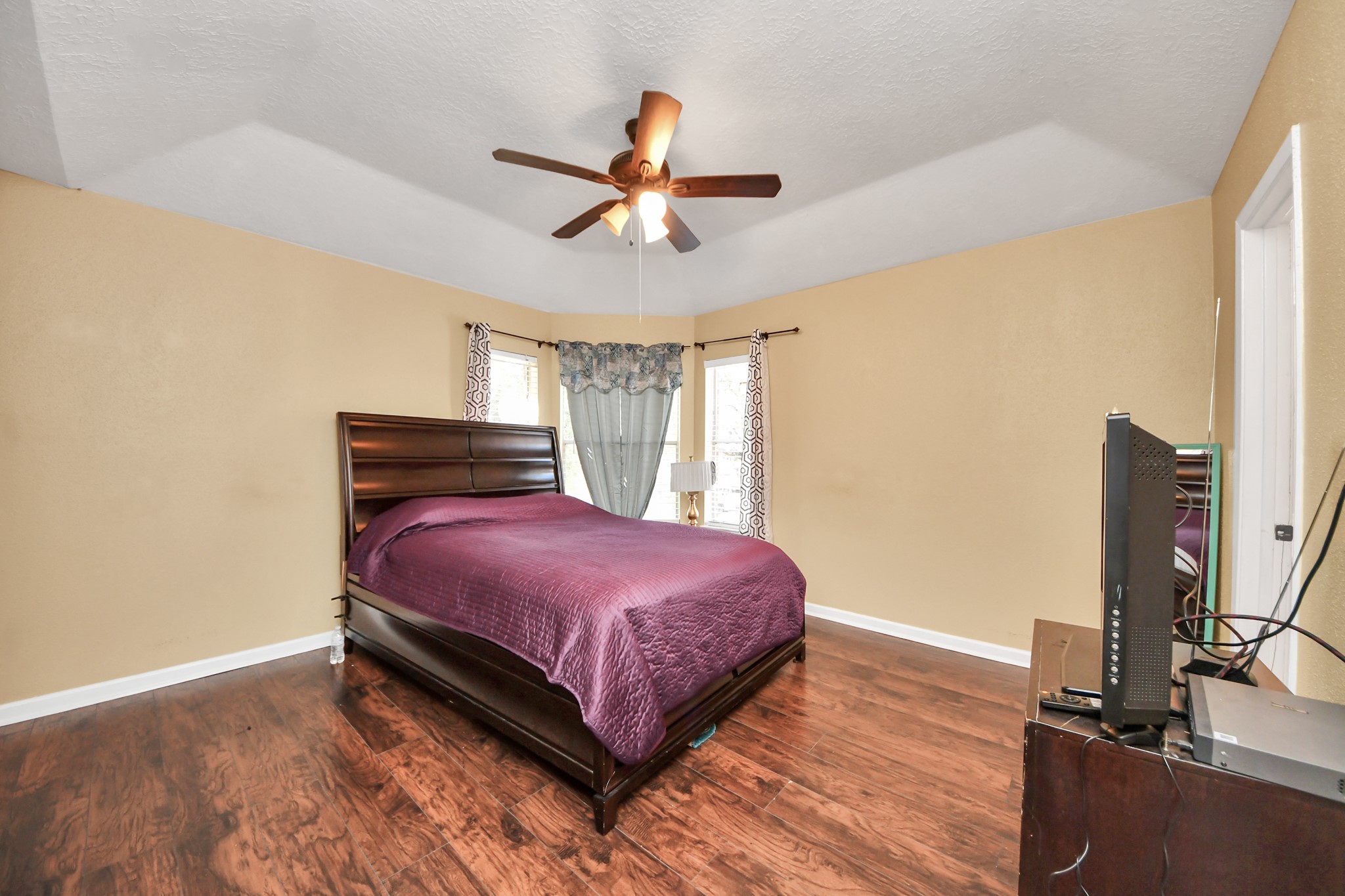 13620 Rosewood Street, Unit 3A Houston, TX 77083 - Photo 20 of 25 a bedroom with a bed and a flat screen tv