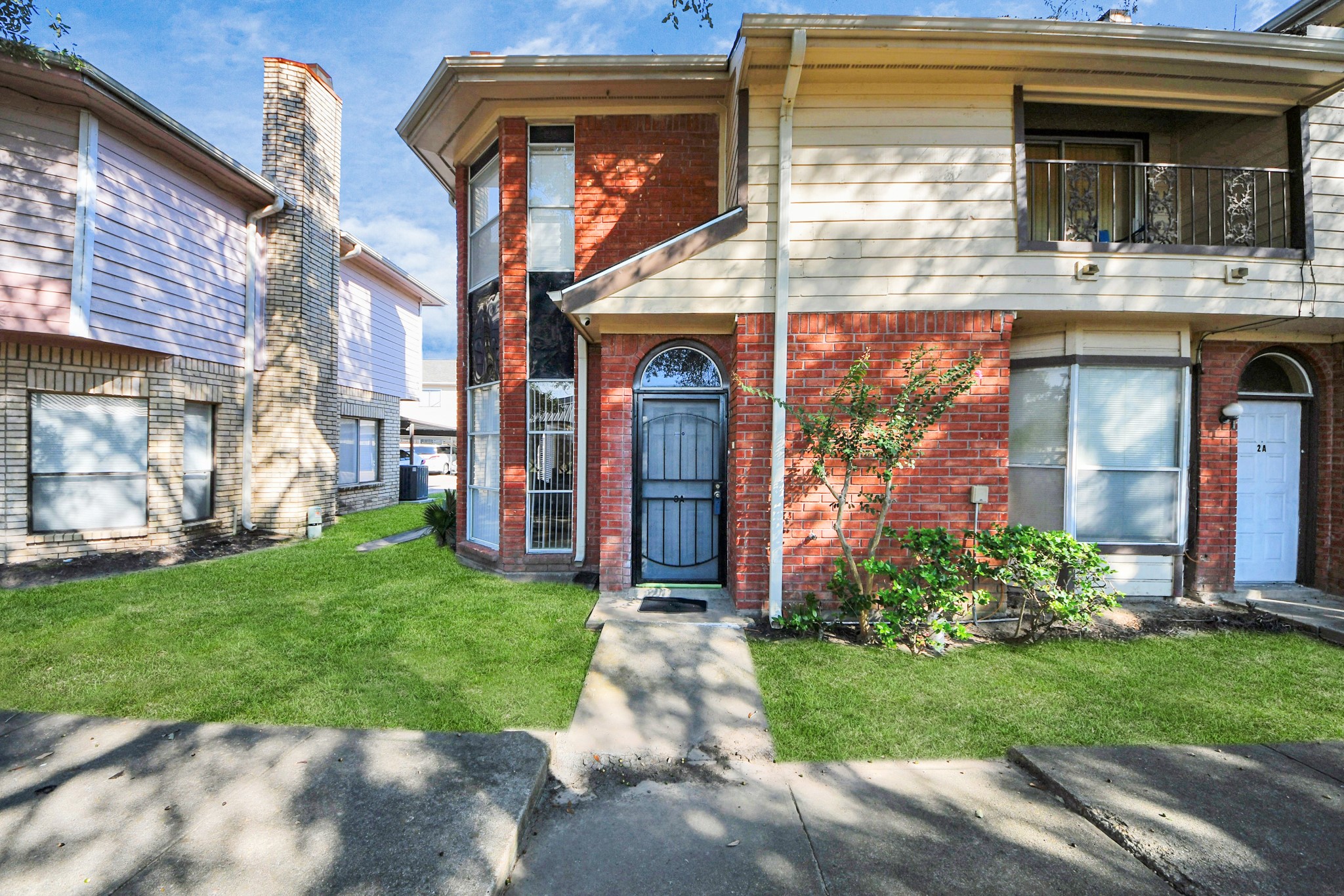 13620 Rosewood Street, Unit 3A Houston, TX 77083 - Photo 2 of 25 a front view of a house with garden