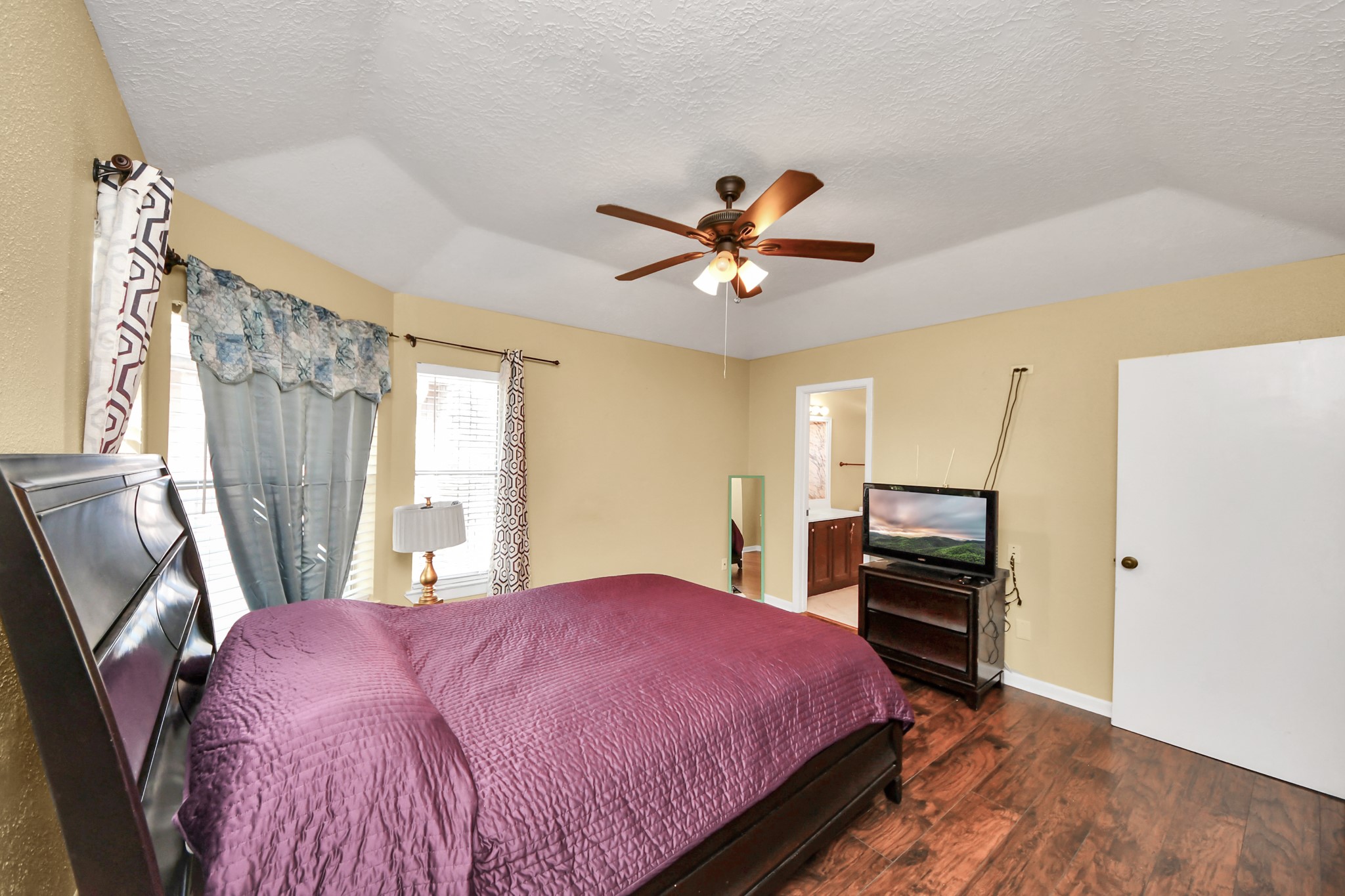 13620 Rosewood Street, Unit 3A Houston, TX 77083 - Photo 21 of 25 a bedroom with a bed dresser and a window