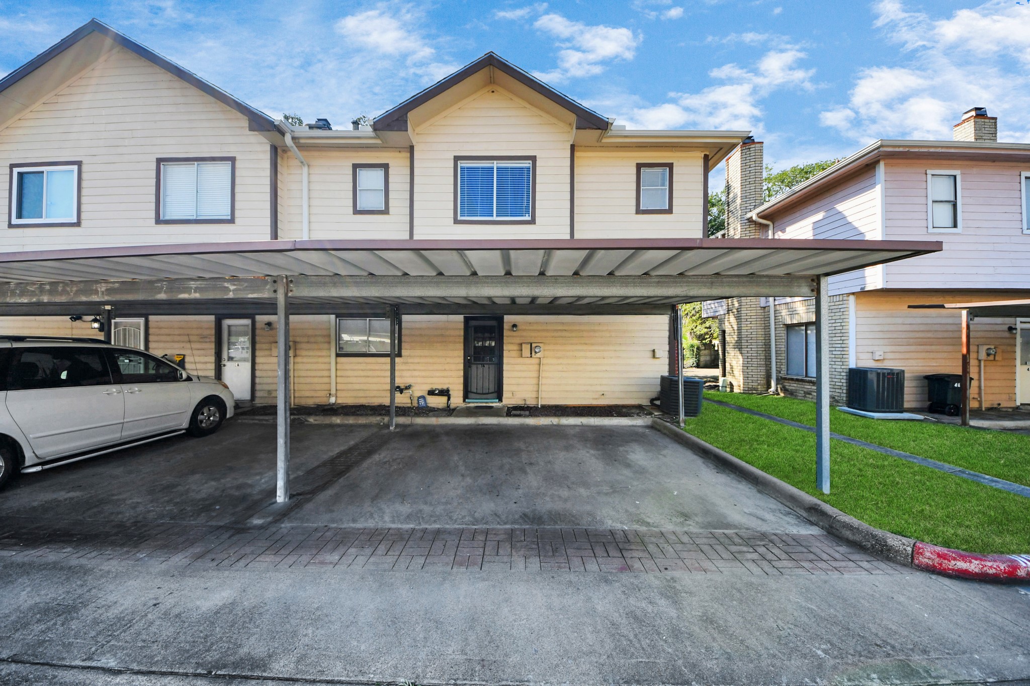 13620 Rosewood Street, Unit 3A Houston, TX 77083 - Photo 24 of 25 a front view of a house with a yard and garage