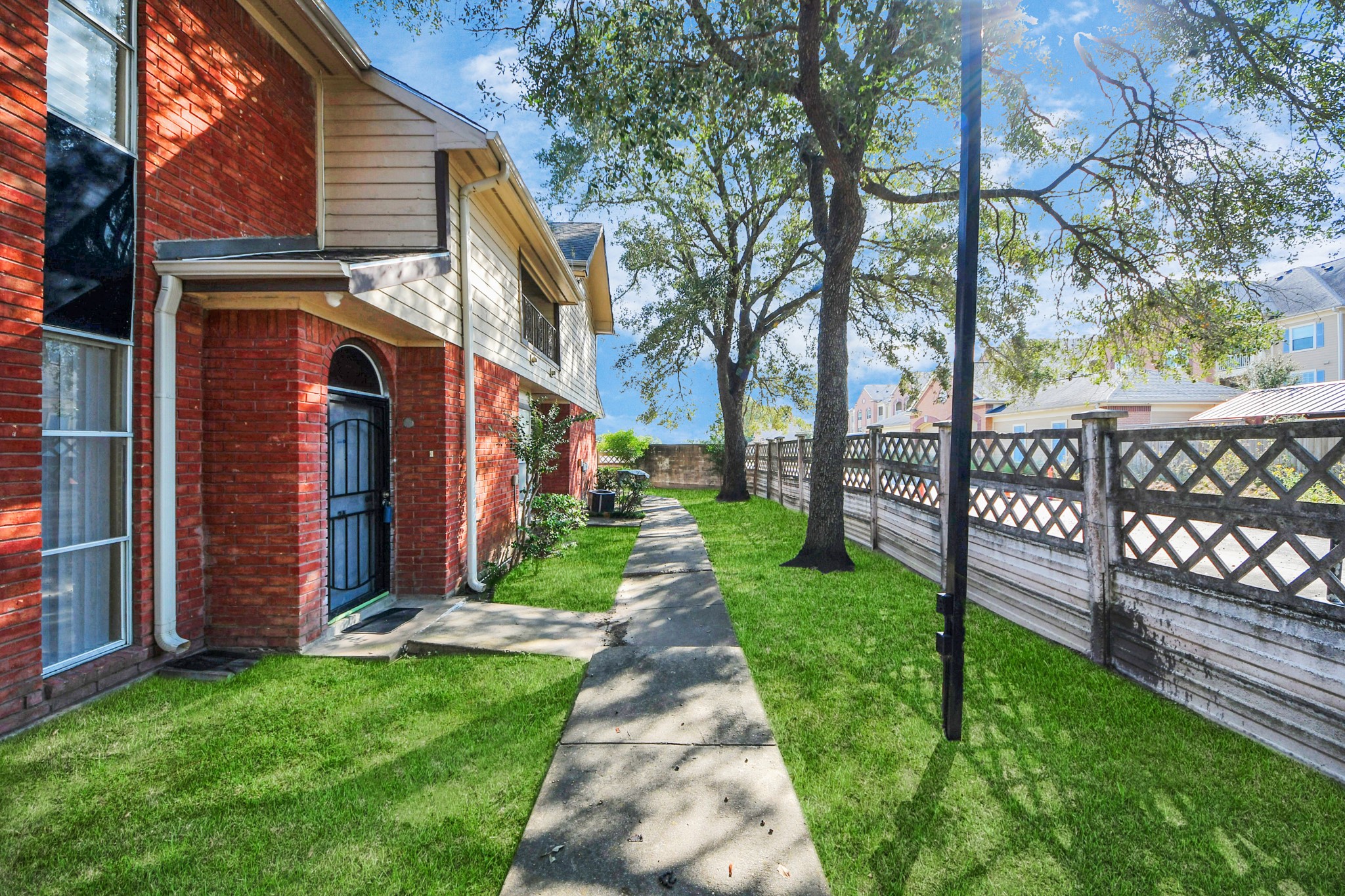 13620 Rosewood Street, Unit 3A Houston, TX 77083 - Photo 3 of 25 a front view of a house with garden