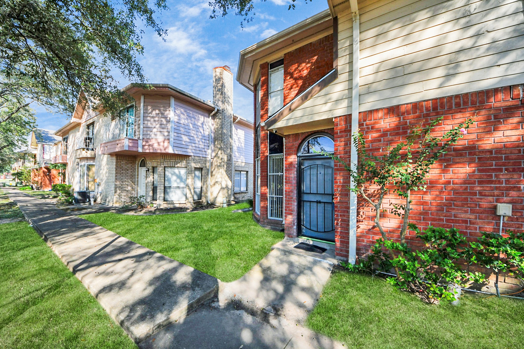 13620 Rosewood Street, Unit 3A Houston, TX 77083 - Photo 4 of 25 a front view of a house with a yard