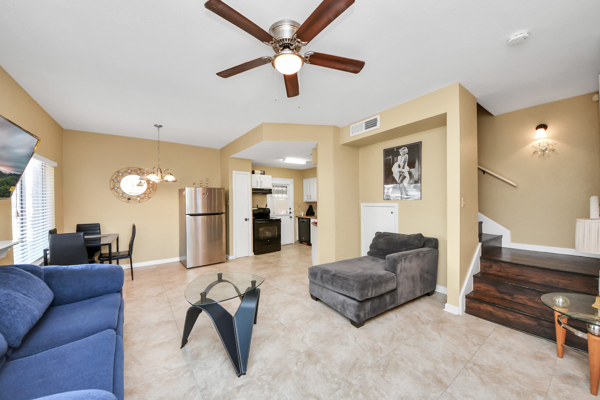 13620 Rosewood Street, Unit 3A Houston, TX 77083 - Photo 10 of 25 a living room with furniture a ceiling fan and a rug
