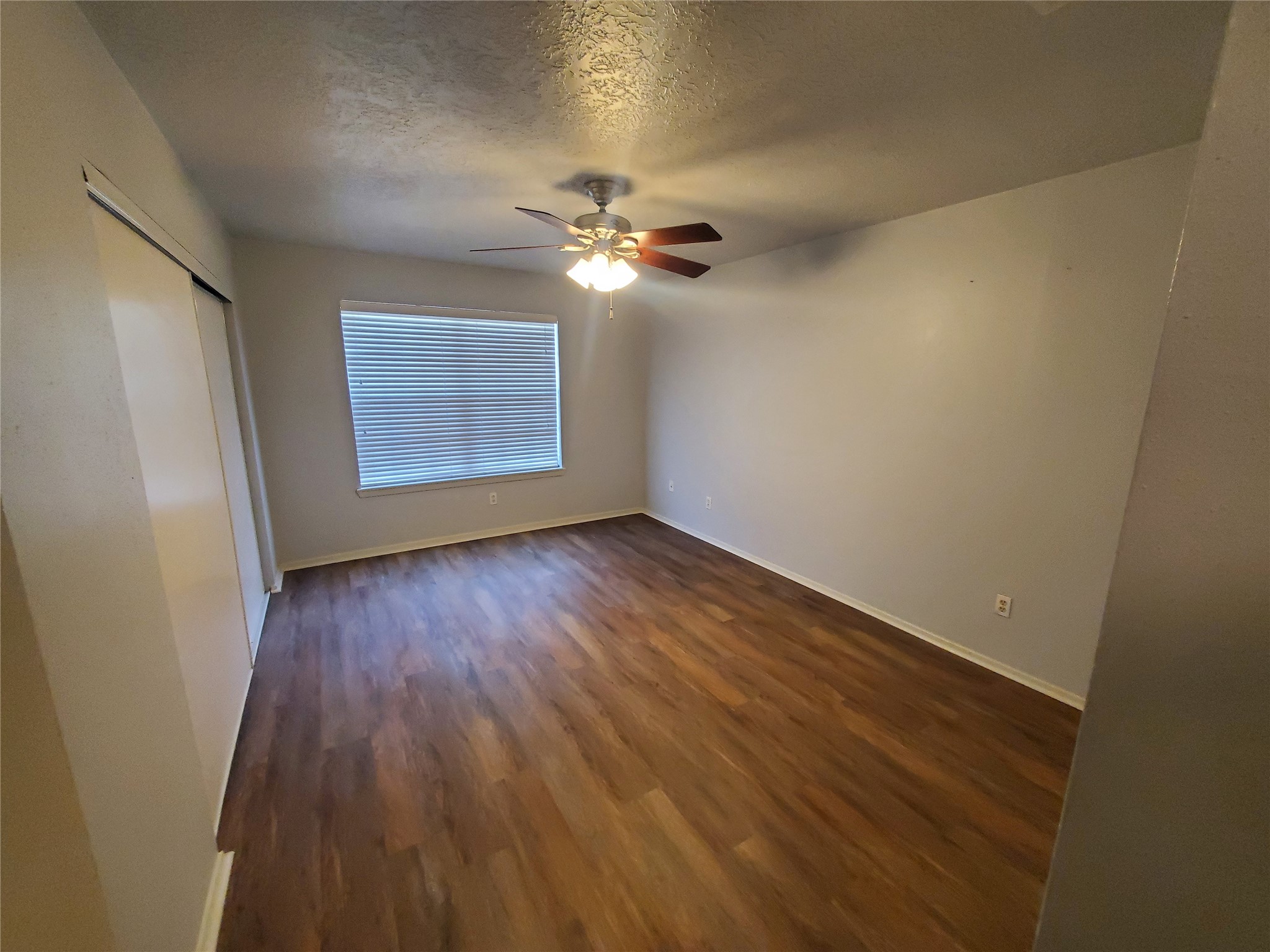 2306 Spring Dusk Drive Spring, TX 77373 - Photo 10 of 12 wooden floor in an empty room with a window