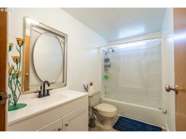 a bedroom with a bed dresser and a window