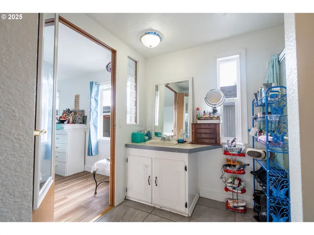 a bedroom with a bed and a wooden floor