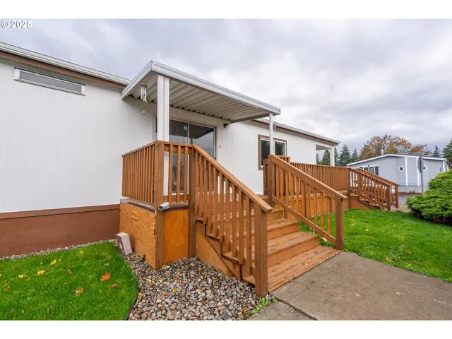 a view of a house with wooden floor in a big yard