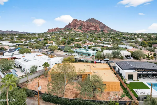 an aerial view of residential houses with outdoor space and river