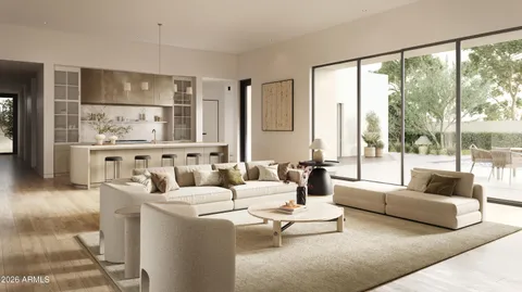 a living room with furniture large windows and wooden floor