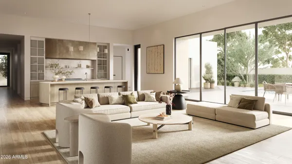 a living room with furniture large windows and wooden floor