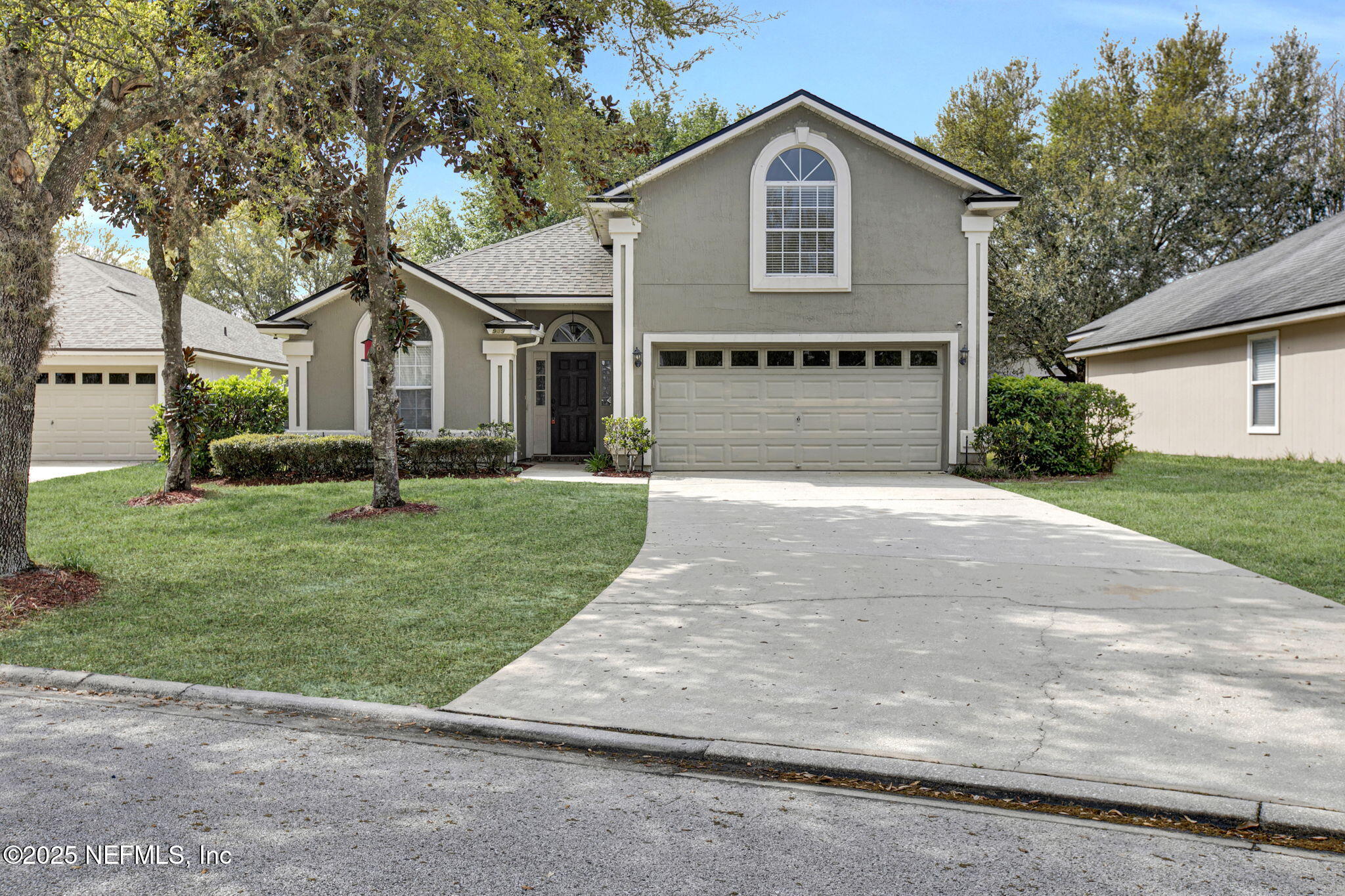 939 Silver Spring Court St. Augustine, FL 32092 - Photo 1 of 31 a front view of a house with a yard and garage