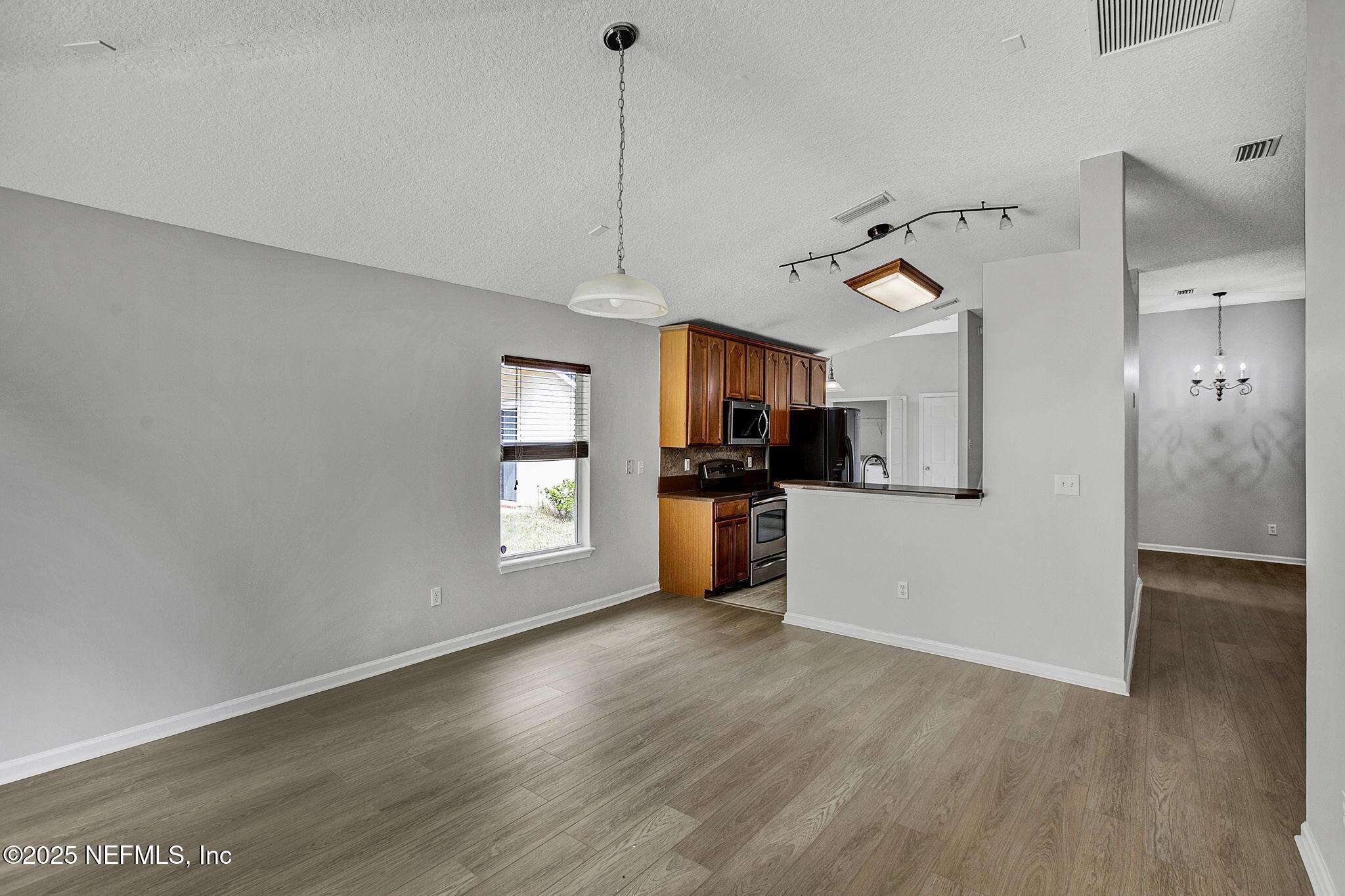 939 Silver Spring Court St. Augustine, FL 32092 - Photo 13 of 31 a view of a kitchen with a sink and a refrigerator