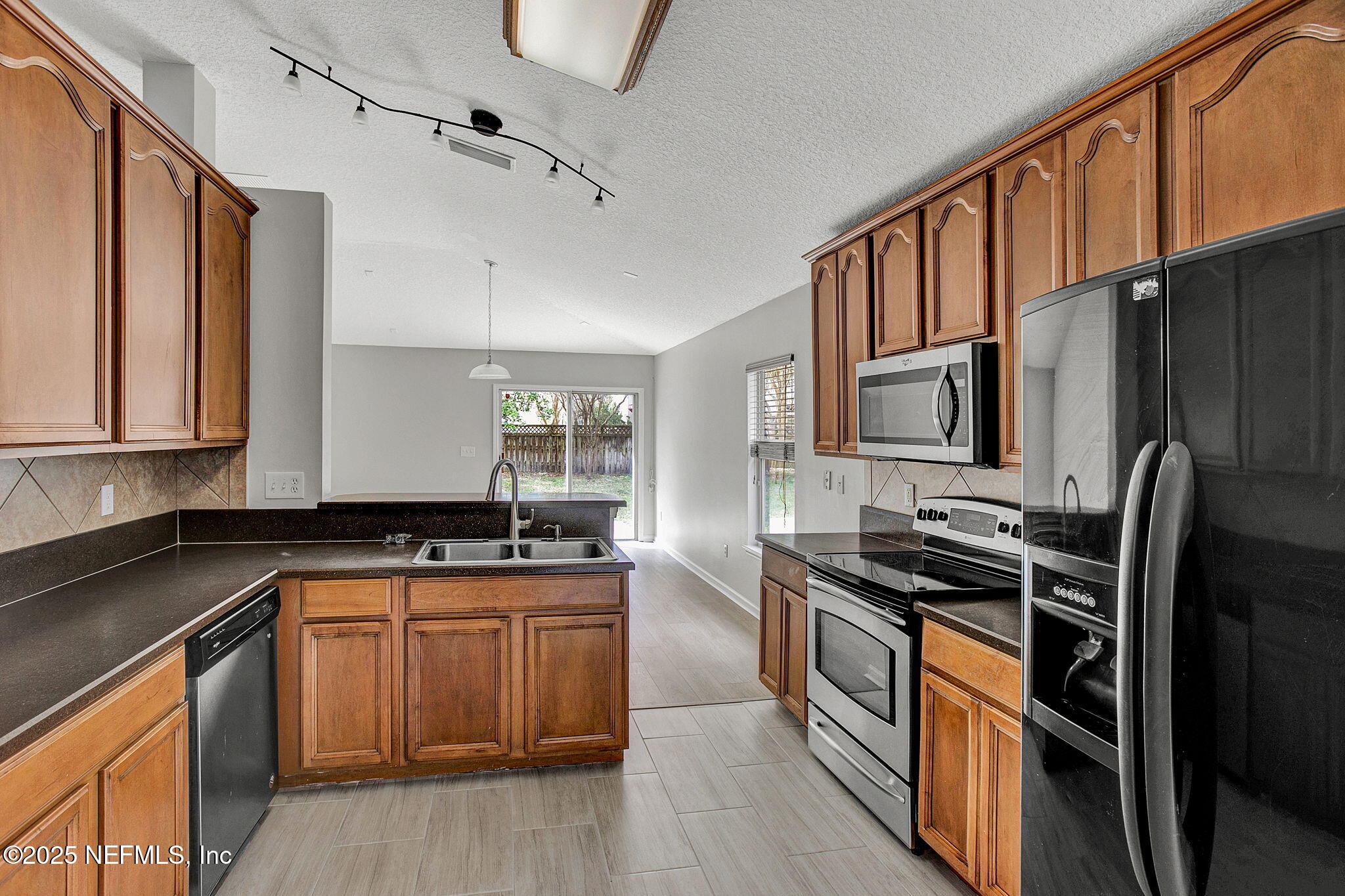 939 Silver Spring Court St. Augustine, FL 32092 - Photo 14 of 31 a kitchen with stainless steel appliances a sink stove and refrigerator