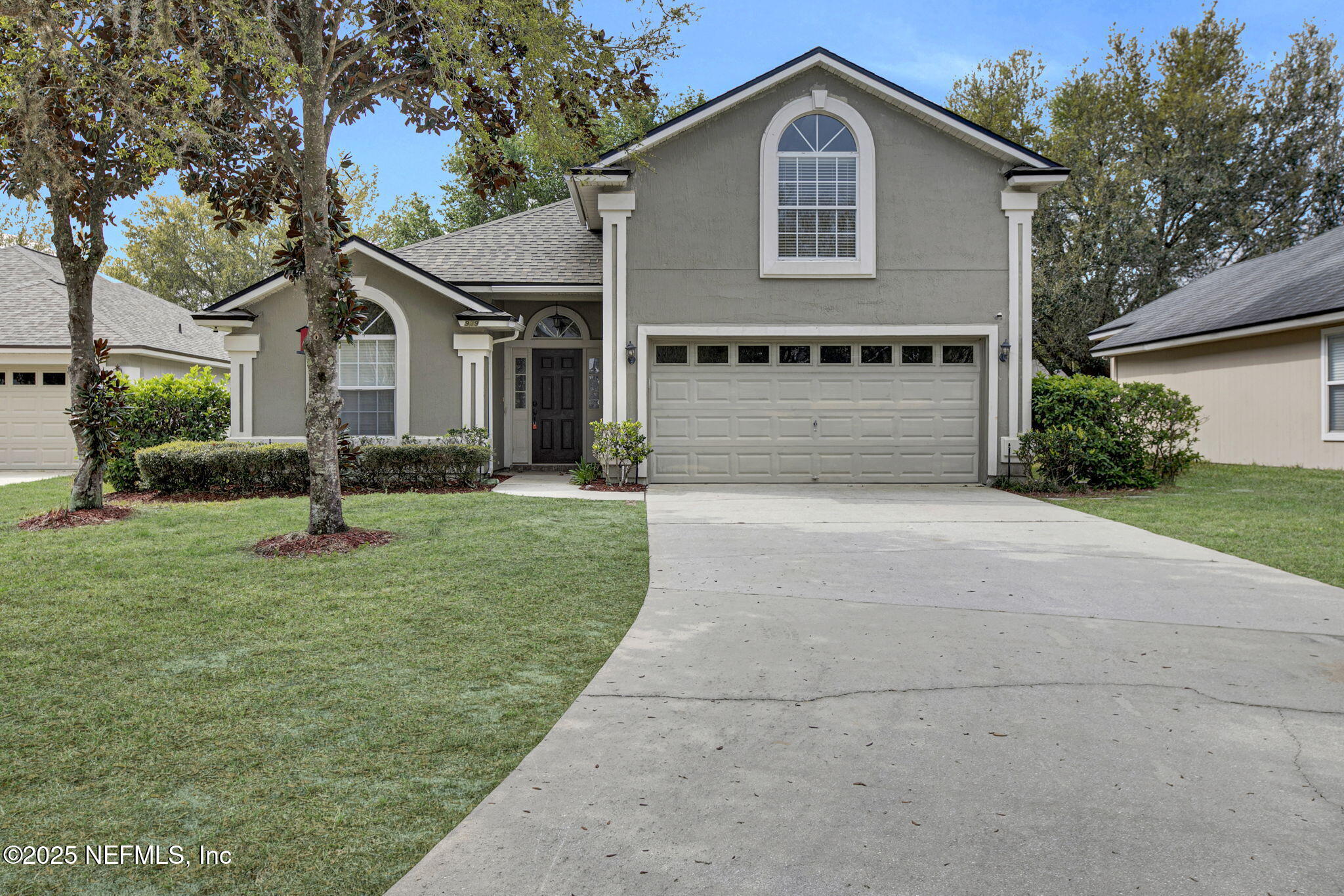 939 Silver Spring Court St. Augustine, FL 32092 - Photo 2 of 31 a front view of a house with a yard and garage