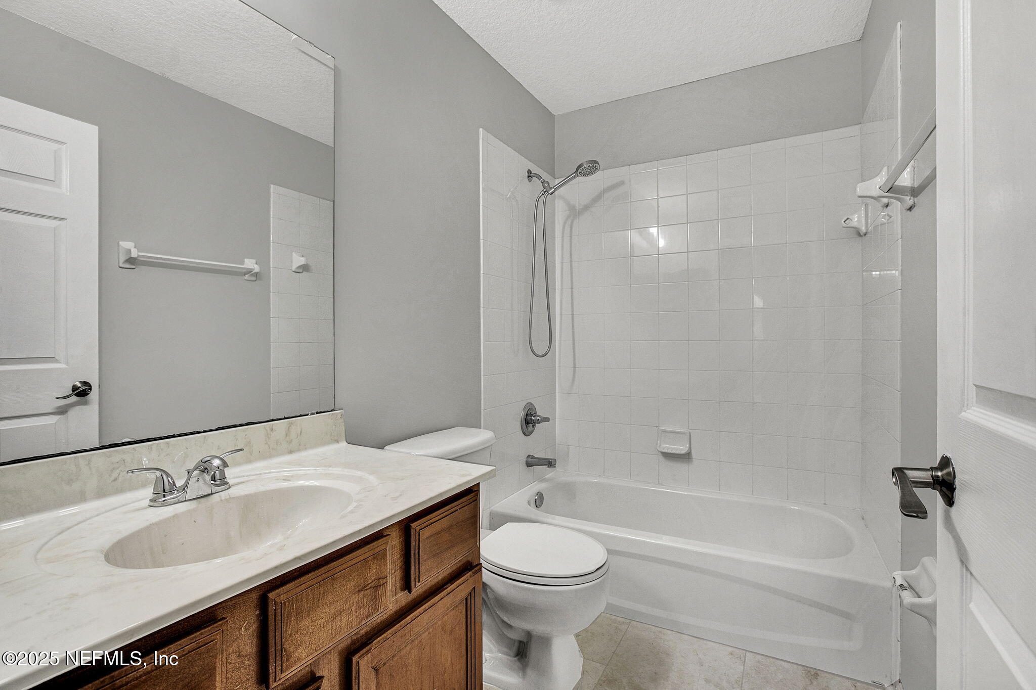 939 Silver Spring Court St. Augustine, FL 32092 - Photo 22 of 31 a bathroom with a granite countertop sink toilet mirror and shower
