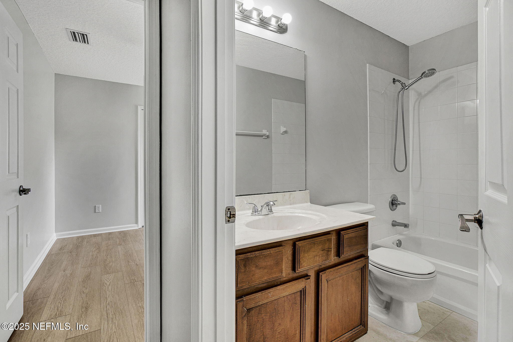 939 Silver Spring Court St. Augustine, FL 32092 - Photo 23 of 31 a bathroom with a granite countertop sink toilet and shower