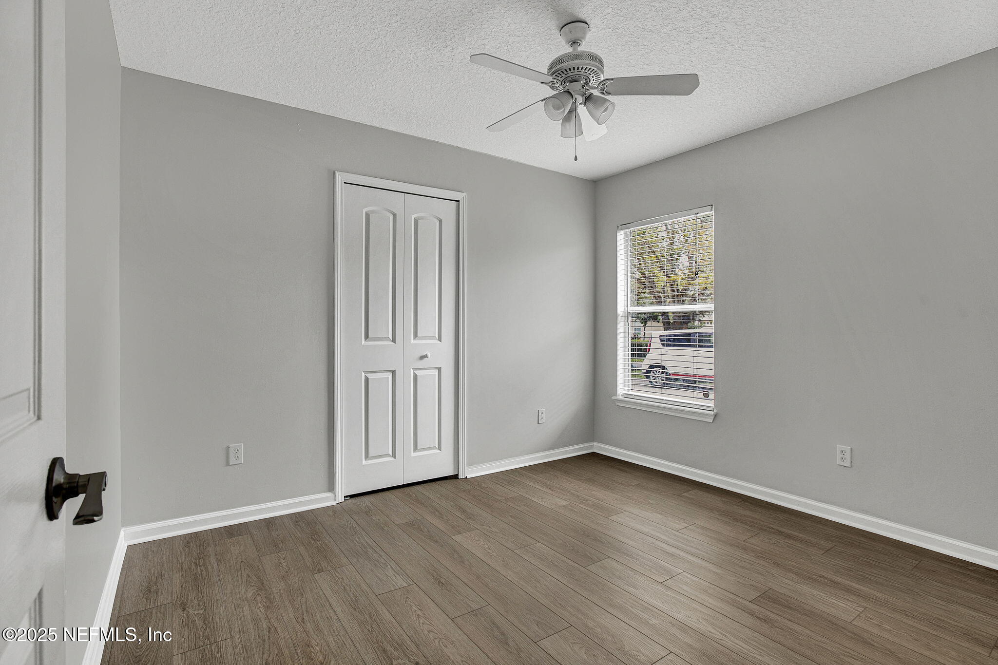 939 Silver Spring Court St. Augustine, FL 32092 - Photo 24 of 31 an empty room with wooden floor chandelier fan and windows