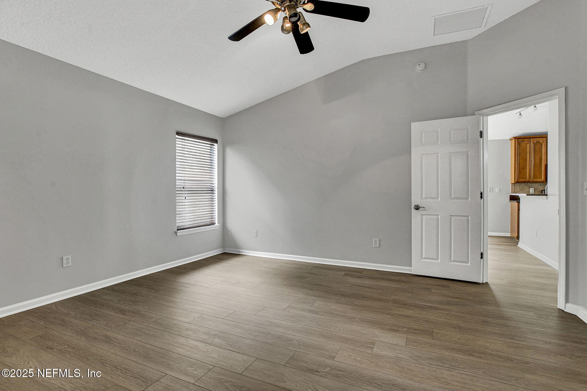 939 Silver Spring Court St. Augustine, FL 32092 - Photo 26 of 31 an empty room with wooden floor and windows