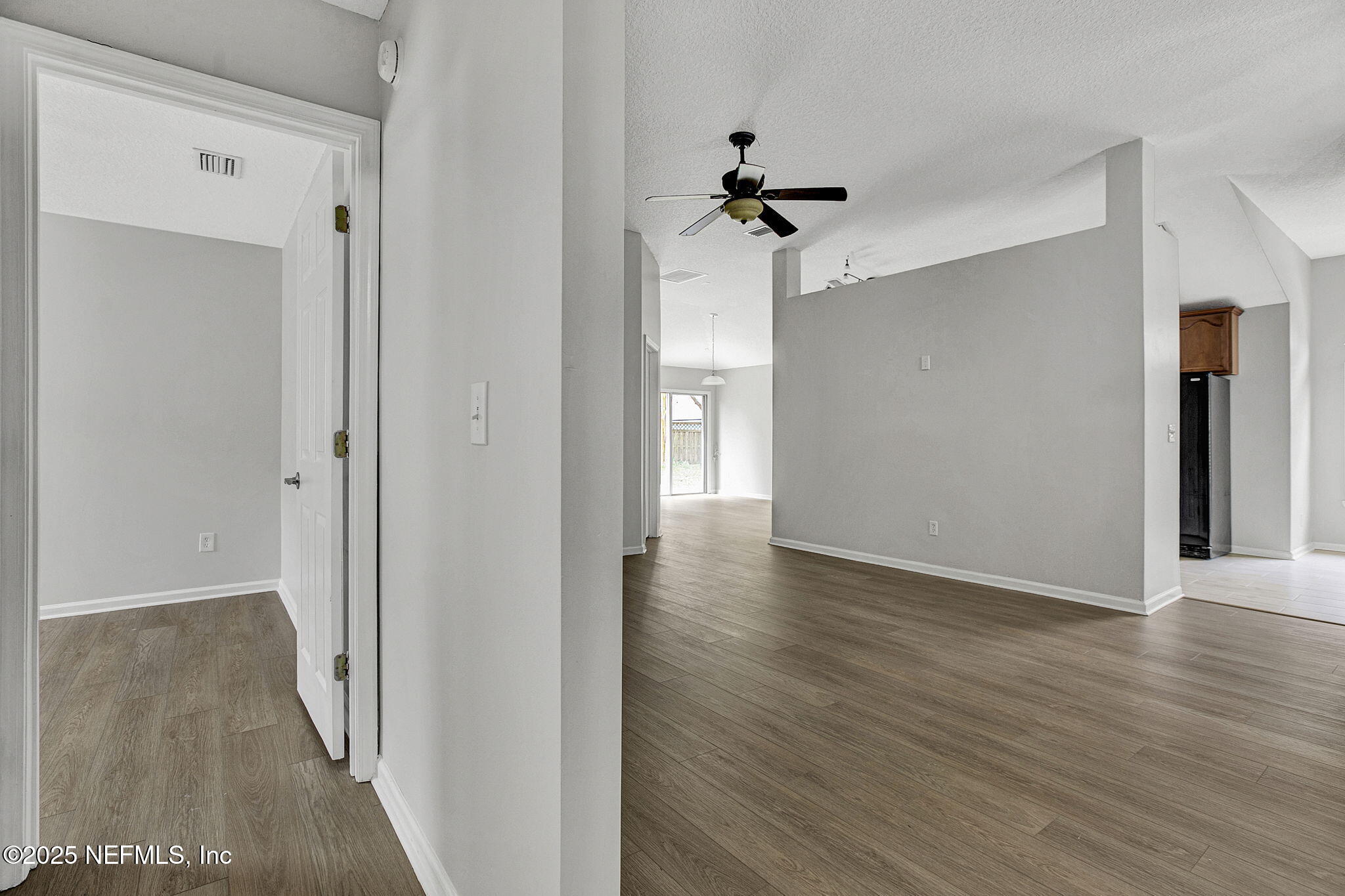 939 Silver Spring Court St. Augustine, FL 32092 - Photo 8 of 31 a view of a hallway with wooden floor and a ceiling fan