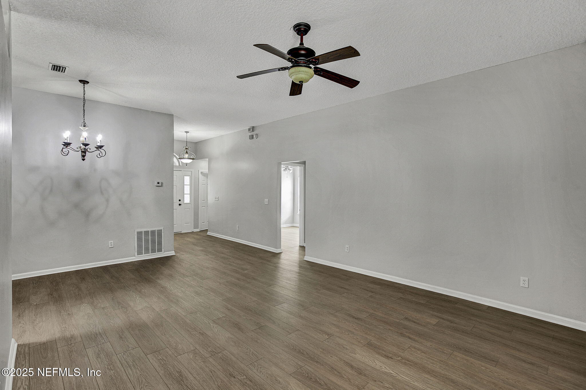 939 Silver Spring Court St. Augustine, FL 32092 - Photo 9 of 31 an empty room with wooden floor and ceiling fan