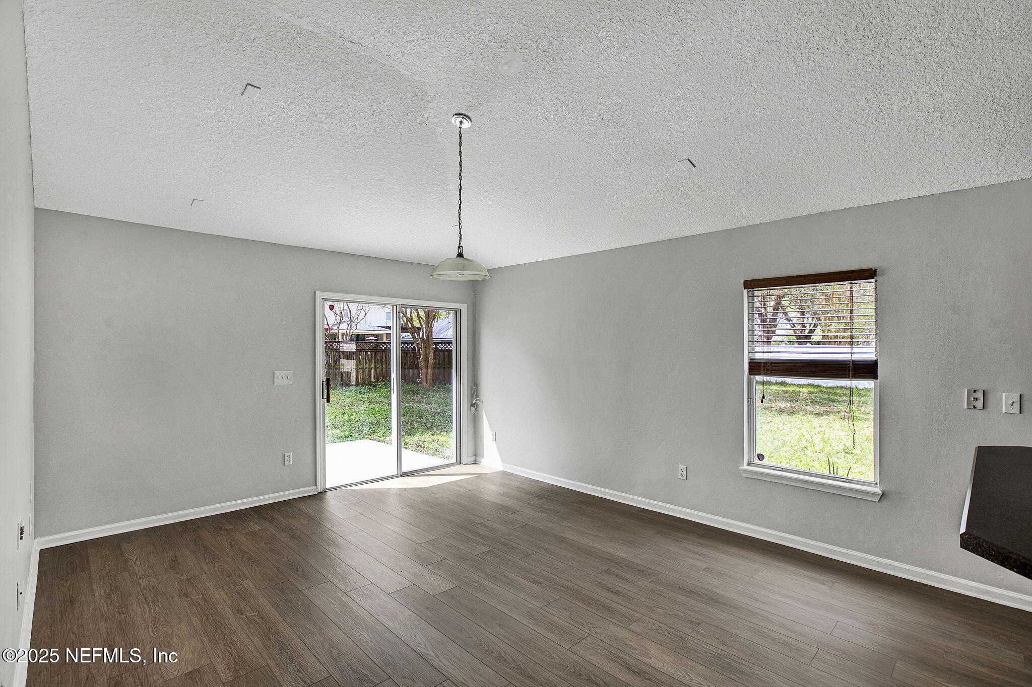 939 Silver Spring Court St. Augustine, FL 32092 - Photo 10 of 31 a view of an empty room with wooden floor and a window