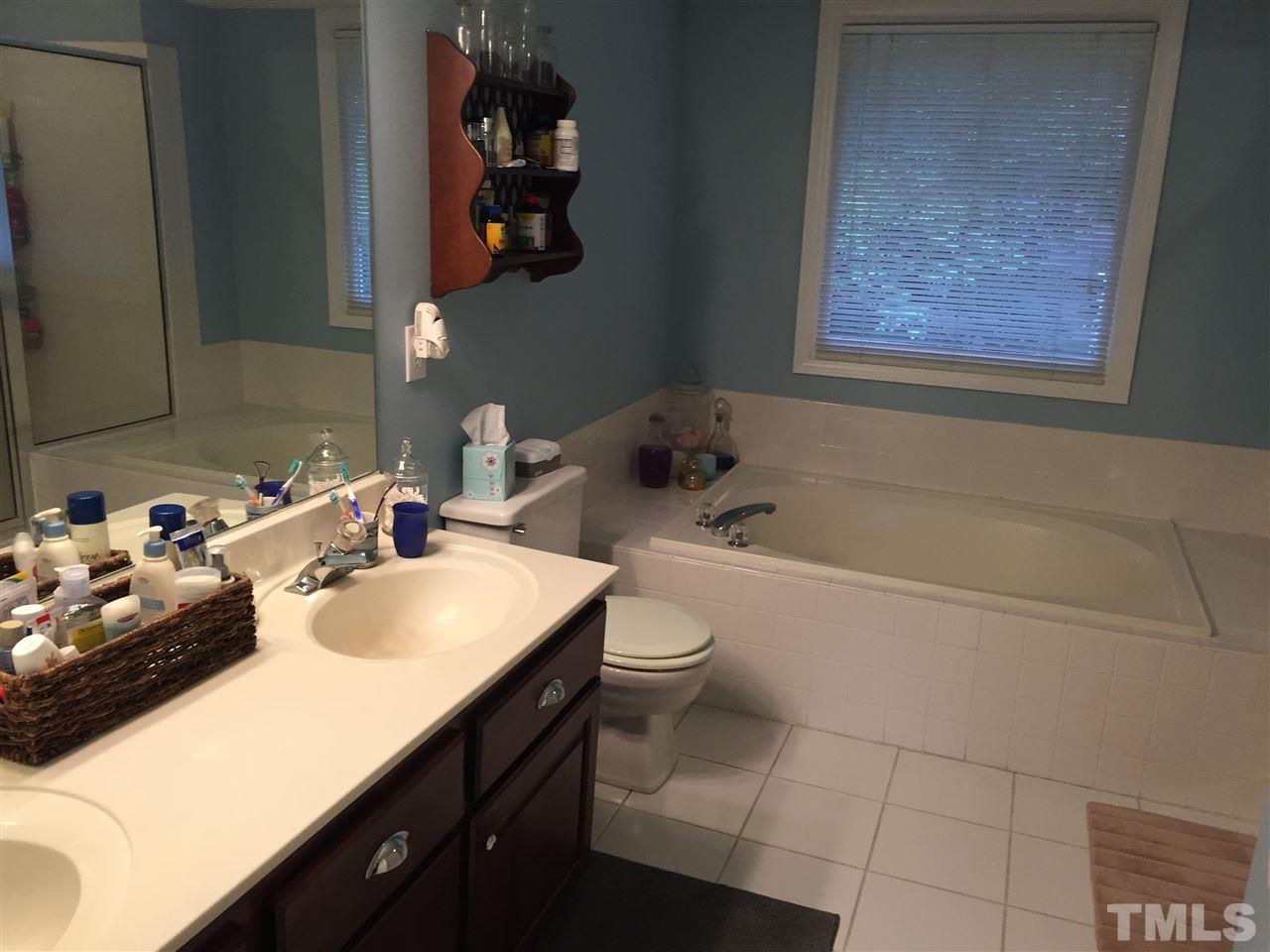 2360 Declaration Drive Raleigh, NC 27615 - Photo 11 of 22 a bathroom with a sink vanity mirror bathtub and toilet