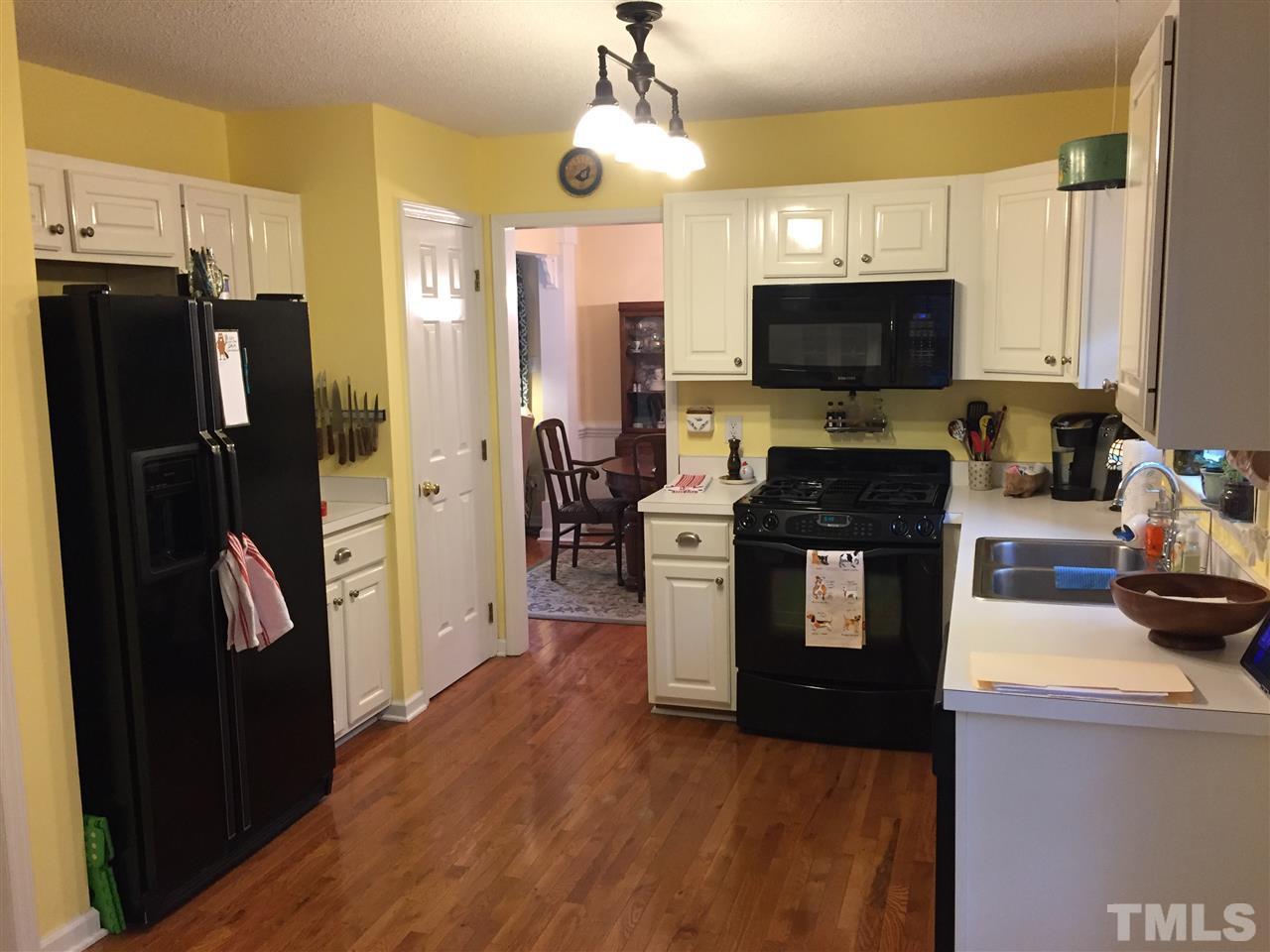 2360 Declaration Drive Raleigh, NC 27615 - Photo 3 of 22 a kitchen with stainless steel appliances kitchen island granite countertop a refrigerator a stove top oven a sink and dishwasher