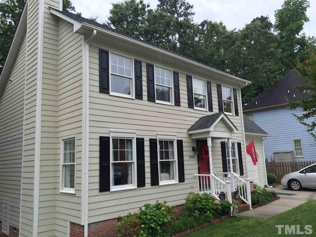 2360 Declaration Drive Raleigh, NC 27615 - Photo 22 of 22 a view of a white house with large windows and plants