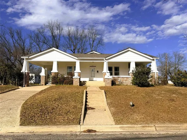 a front view of a house with yard porch and outdoor seating