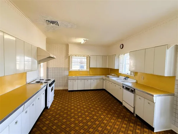 a kitchen with a sink a counter top space and appliances