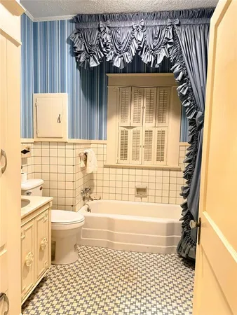 a bathroom with a toilet a sink and a shower