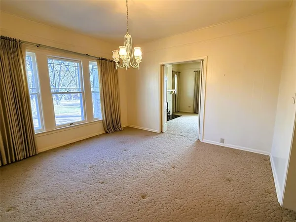 an empty room with windows and entrance