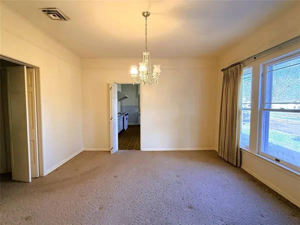 a view of a livingroom with a fireplace cabinet and windows