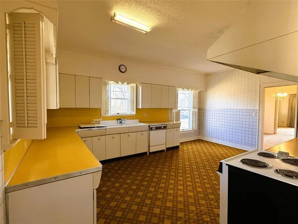 a kitchen that has a sink and a stove