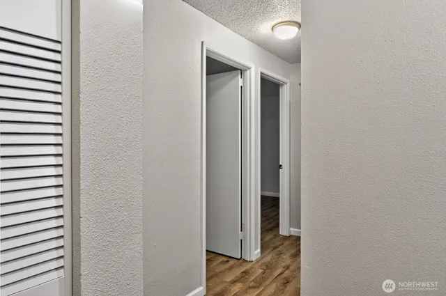 a view of a hallway with wooden floor