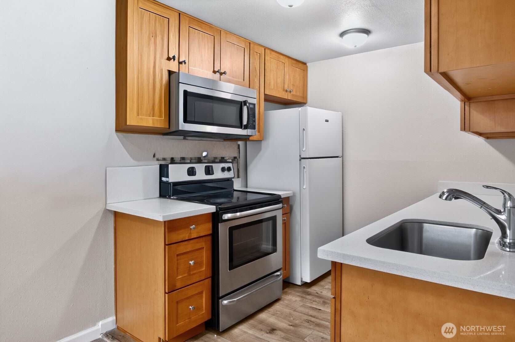 1601 Maple Lane, Unit B1 Kent, WA 98030 - Photo 4 of 20 a kitchen with a stove and a microwave