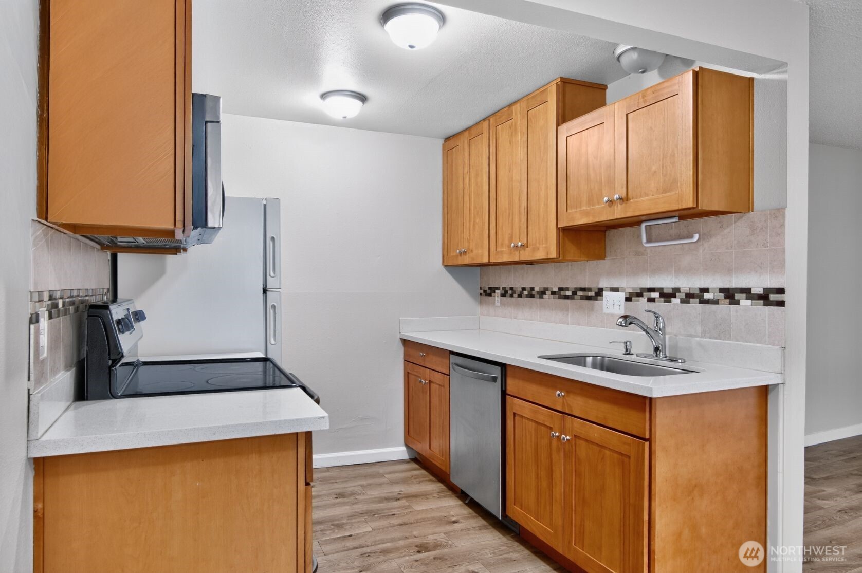 1601 Maple Lane, Unit B1 Kent, WA 98030 - Photo 5 of 20 a kitchen with stainless steel appliances granite countertop a sink stove and cabinets