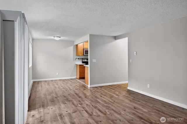 a view of a kitchen with wooden floor and a sink