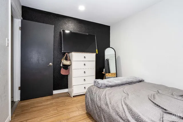 a bedroom with a bed and a dresser