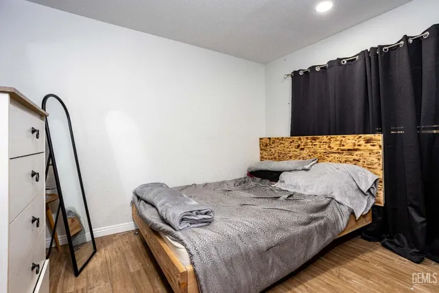 a bed sitting in a bedroom next to a window