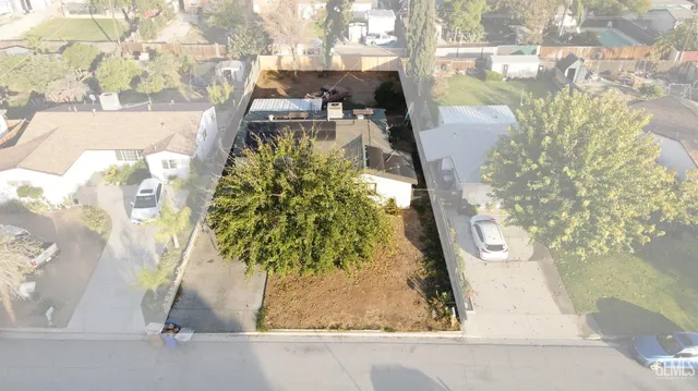 an aerial view of a house with a yard and garden
