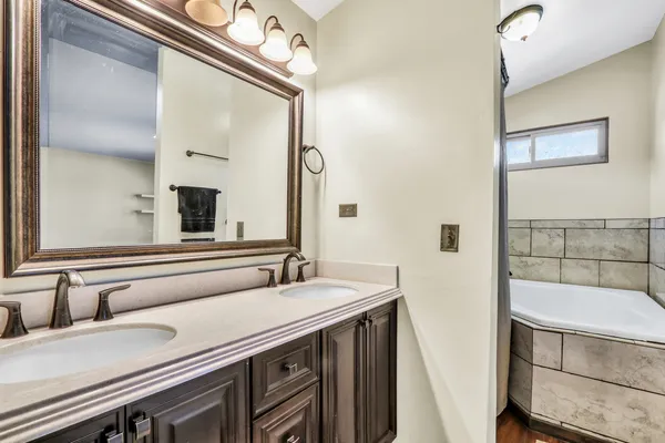 a bathroom with a white bath tub and shower