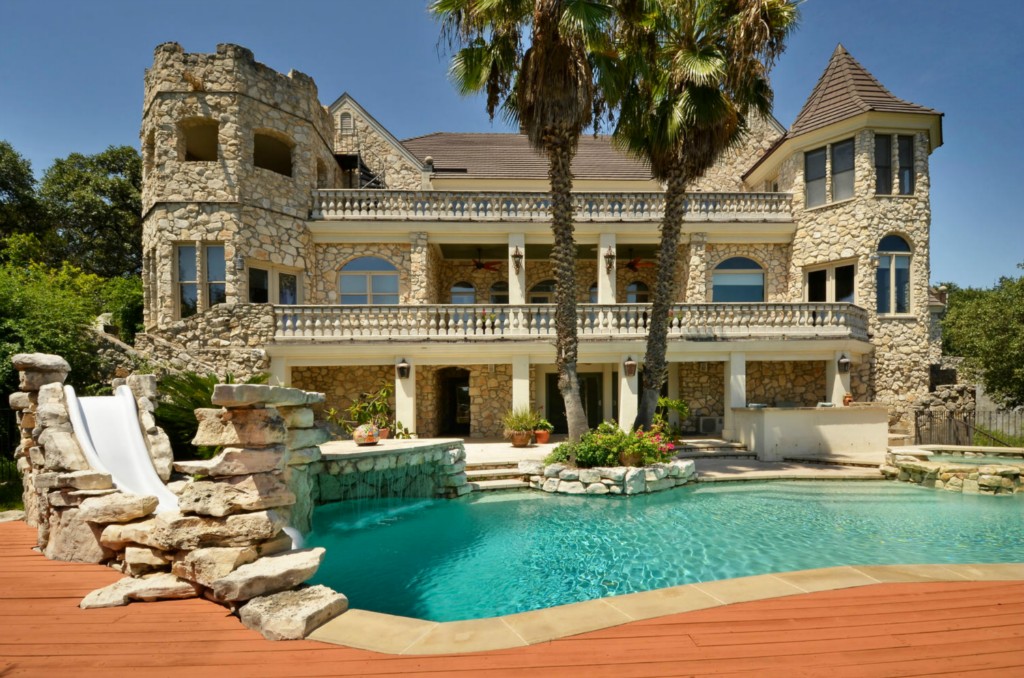 a front view of a house with a garden and plants