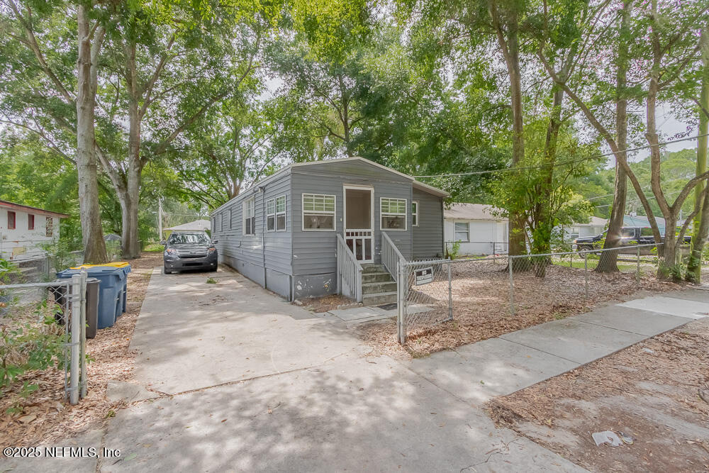 9042 7th Avenue Jacksonville, FL 32208 - Photo 1 of 22 a view of a house with a yard and large trees