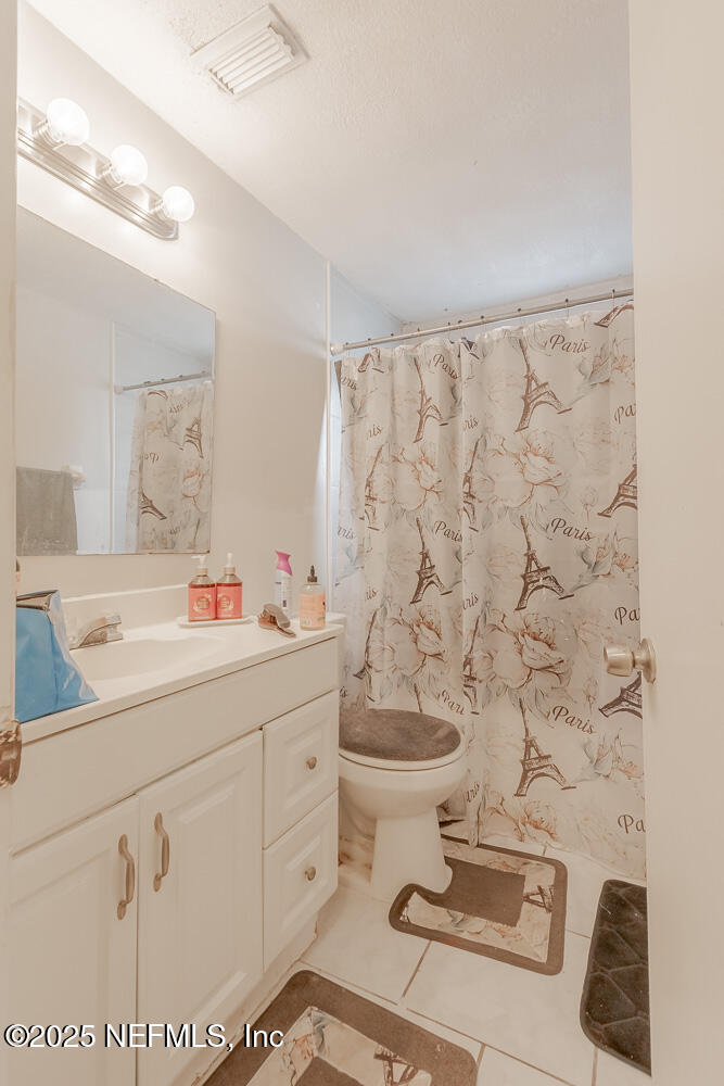 9042 7th Avenue Jacksonville, FL 32208 - Photo 13 of 22 a bathroom with a sink toilet and shower