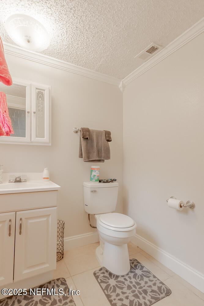 9042 7th Avenue Jacksonville, FL 32208 - Photo 19 of 22 a bathroom with a toilet a sink and mirror