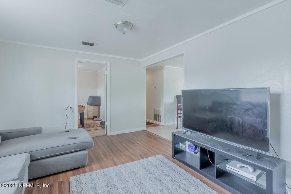 9042 7th Avenue Jacksonville, FL 32208 - Photo 6 of 22 a living room with furniture and a flat screen tv