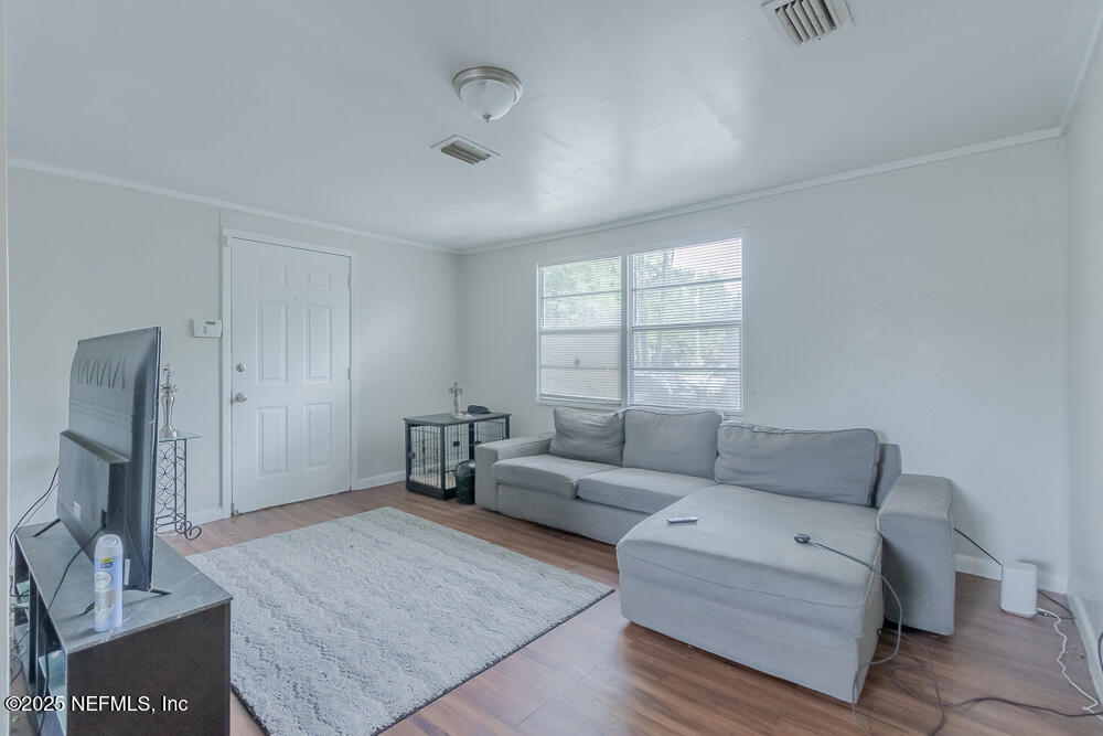 9042 7th Avenue Jacksonville, FL 32208 - Photo 7 of 22 a living room with furniture and a window