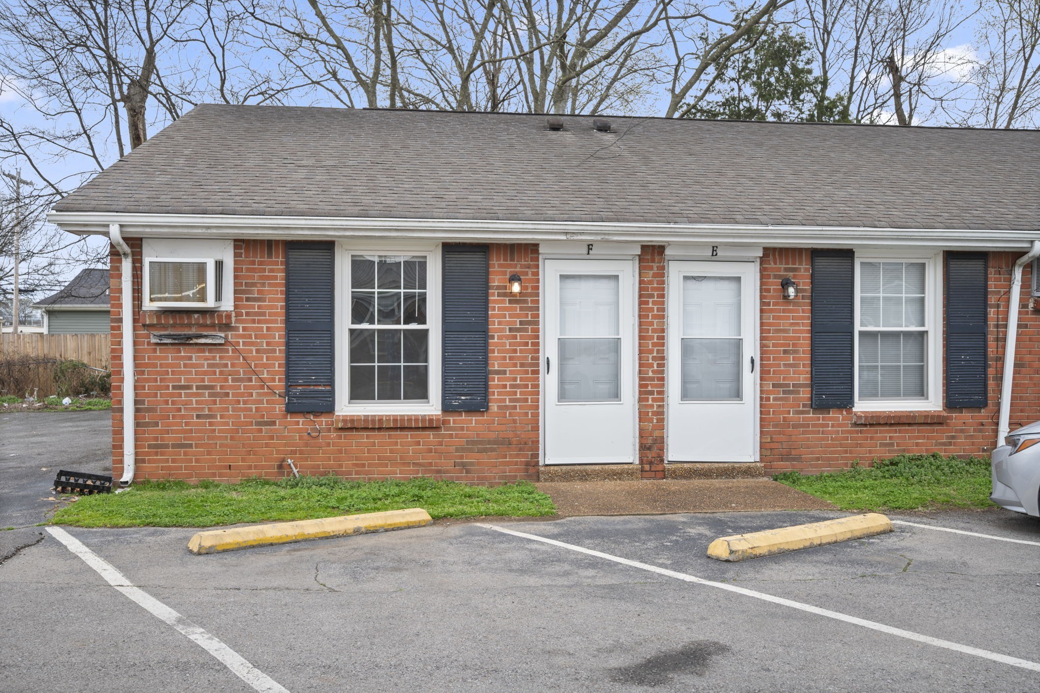 703 Power Street, Unit B Clarksville, TN 37042 - Photo 1 of 13 a front view of a house with a yard and a garage