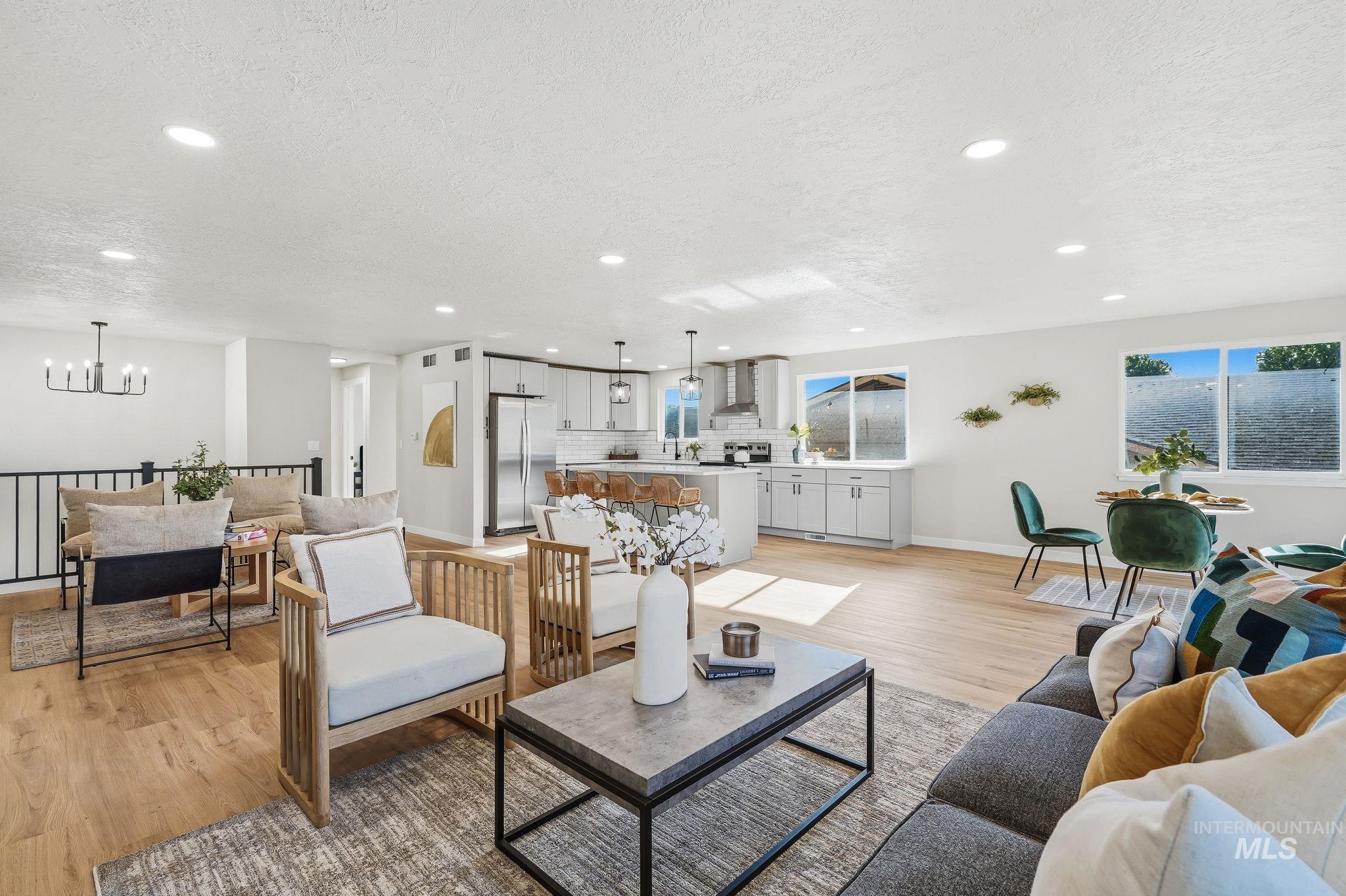 1990 Panama Street Boise, ID 83705 - Photo 12 of 50 Open-concept living space featuring wood-finish flooring, recessed lighting, and a contemporary chandelier